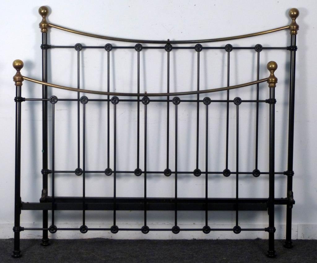 Cast Iron and Brass Bed: Painted black frame with brass finials and crest. With rails. Headboard: 60" W X 57 1/2 " H; Footboard 45 1/2" H.