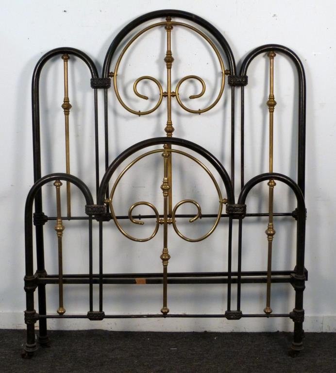 American Iron and Brass Bed: Cast iron mounts with brass accents, headboard and footboard, complete with rails, headboard: 56" W x 6" H, footboard: 56" W x 44" H.