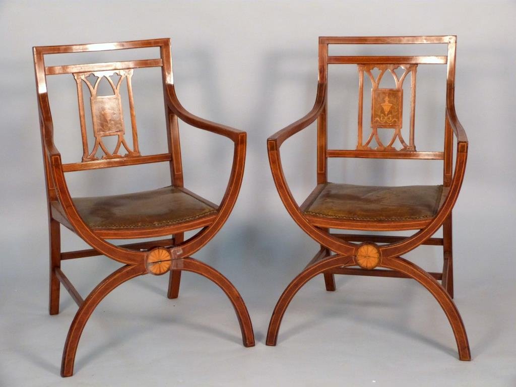 Pair of English Edwardian Arm Chairs (as is): Line and rosette and ribbon inlays, studded leather seats. 23" W X 20" D X 35" H. 1 as is (missing stretcher), from a corporate collection.