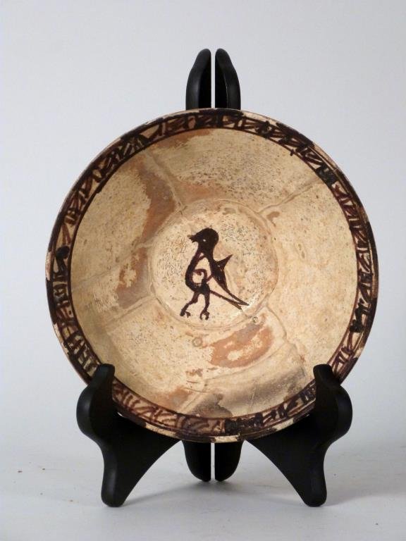 Islamic Ceramic Bowl: A conical form with cream-glazed interior and brown-painted band at rim and bird at center. 7 1/4" D X 3" H. Repaired.