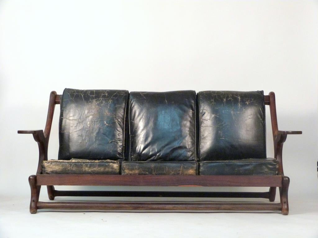 Don Shoemaker Settee: Sculpted wood with leather sling backs and slip seat cushions. 74 1/2" W X 32" D X 33" H.
