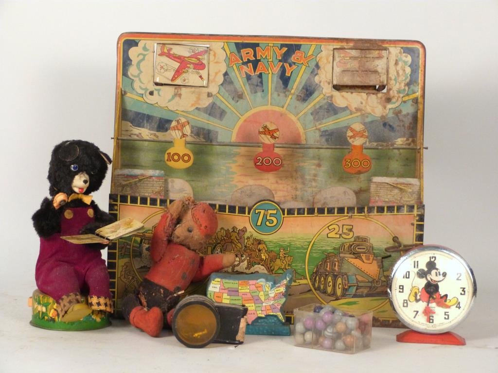 Louis Marx & Co Target Game & Other Toys: US toy bank, battery powered bear reading book, straw stuffed teddy bear, Marx target game with lithographed war scenes, Bayard Mickey clock, Aeroloop, and clay marbles.