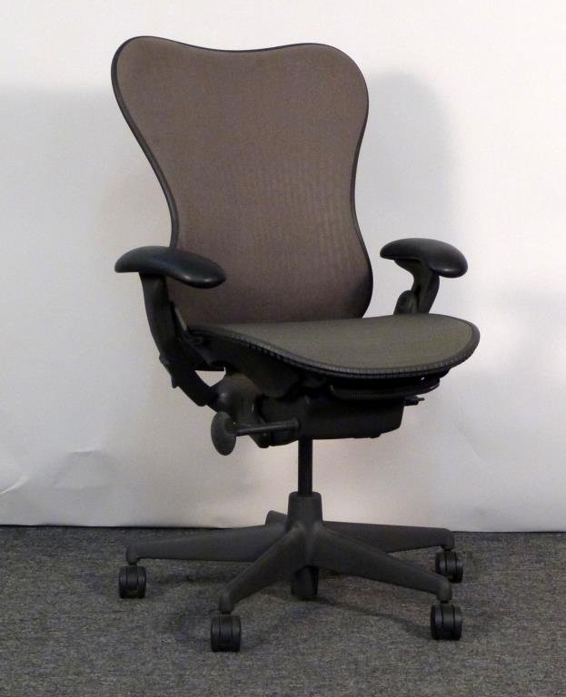 Herman Miller Aeron Chair: Brown/grey mesh back, green/grey mesh seat. 28 1/2" W X 26" D. Some staining to seat back, some abrasion to rubber. (From an East Side Townhouse)