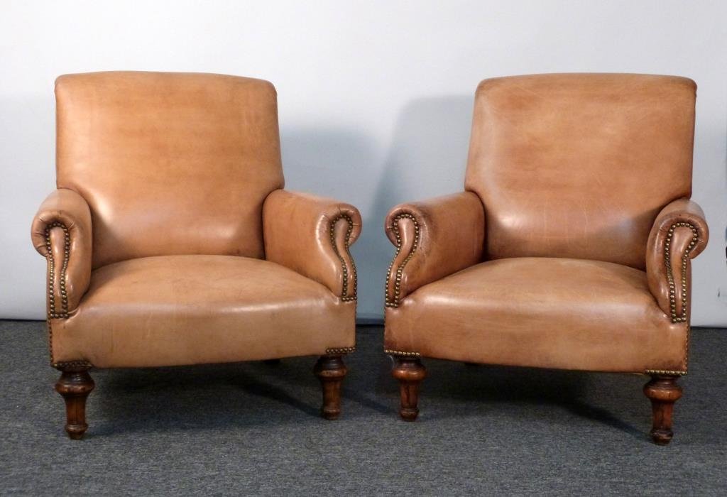 Pair of Ralph Lauren Home Leather Club Chairs: Low seats, swooping backs, studded upholstery, turned front legs. 32" W X 41" D X 35" H.