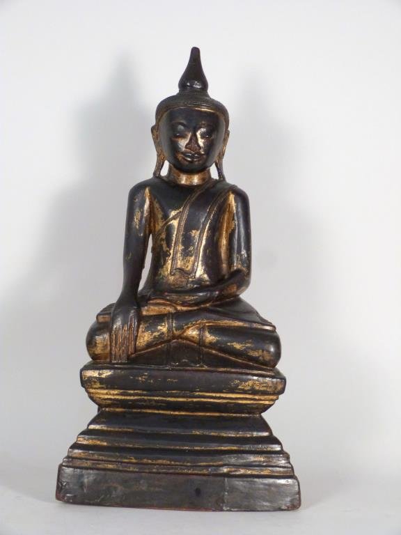 Thai Style Wood Figure of Buddha: Ebonized and gilt. 22" H. Chip off top finial. (From a 45 Sutton Place South Former Jewelry Designer)