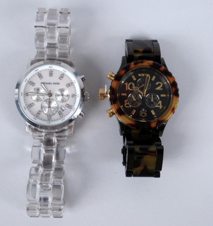 2 Ladies' Watches: Michael Kors with clear plastic band and Nixon with faux tortoise band.