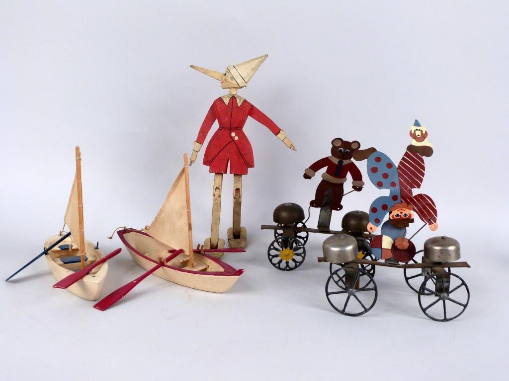 5 Folk Art Style Toys: 2 carved wood boats, articulated carved wood Pinocchio (12" H), and 2 painted metal pull toys. (Madison Avenue NYC Estate)