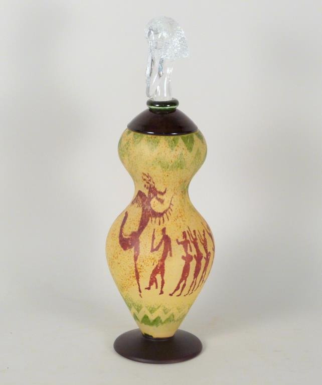 Kjell Engman by Kosta Boda Art Glass Covered Jar: Decorated jar with African figures, top clear and colored glass with male head finial, both top and base signed, receipt from The Gallery, Stockholm. 18" H. (From a 45 Sutton Place South Former Jewelr