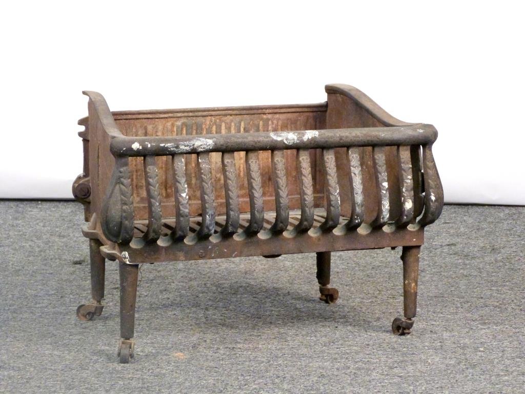 Cast Iron Fire Grate: Floral front ribs, on casters. 19" W X 11" D X 13" H. (925 Park Ave Estate)