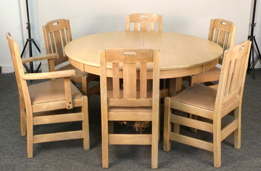 Quaint Stickley Brothers Dining Table & Chairs: Cerused oak, table with 4 leaves, 5 side chairs, 1 arm chair. Table: 54" D X 29" H, leaves: 11" W; side chair: 19" W X 19" D X 36" H; arm chair: 26 1/2" W X 21" D X 37" H. Leaves tinted differently fr