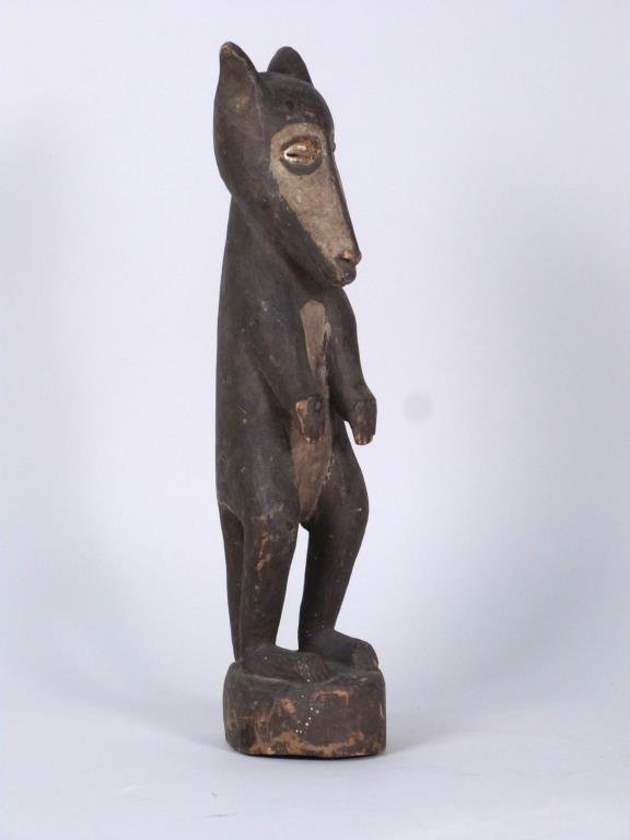 Aboriginal Bear Figure: Carved wood with black n tan pigment, inset cowry shell eyes. 13" H. Crack to back.
