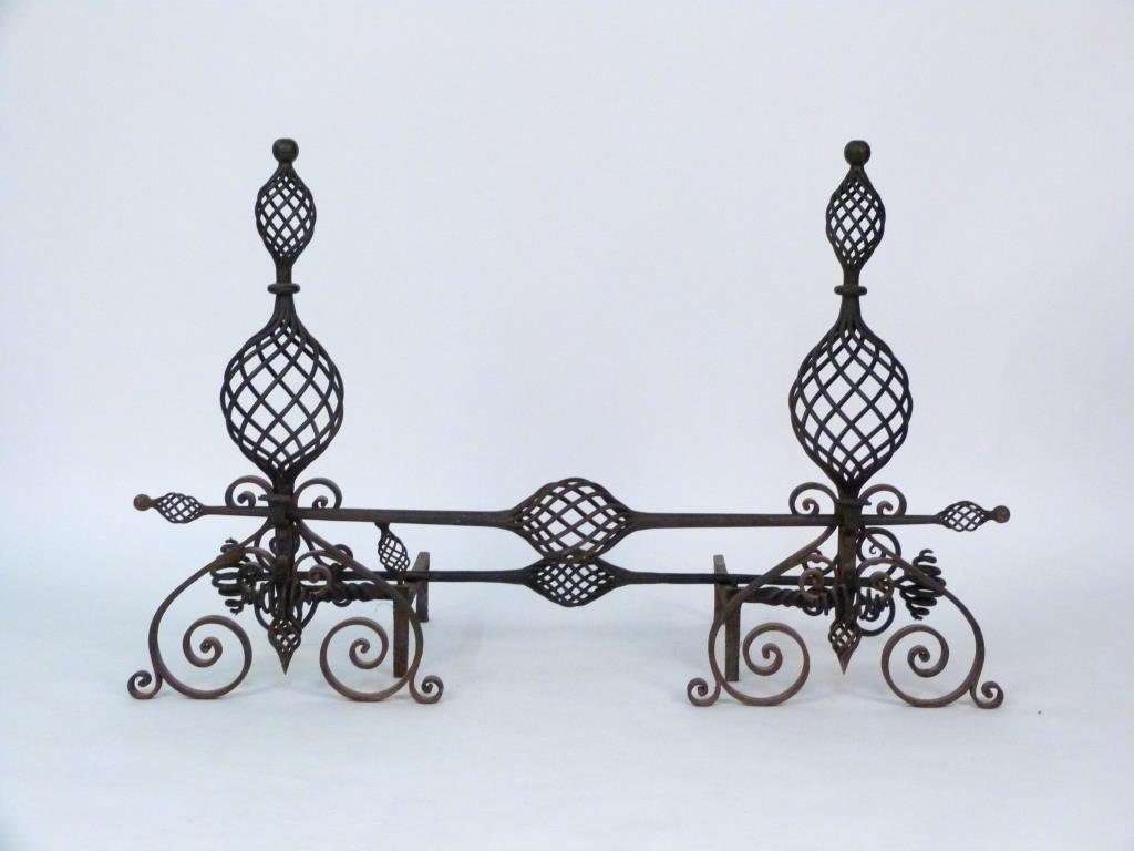 English Wrought Iron 4 Piece Fireplace Set: Pair of andirons and two connecting rods, open swirl designs. Andirons: 23 1/2" D X 33" H; longer rod: 50" L. 1 andiron missing lower finial. (Prospect Park Brooklyn Property)
