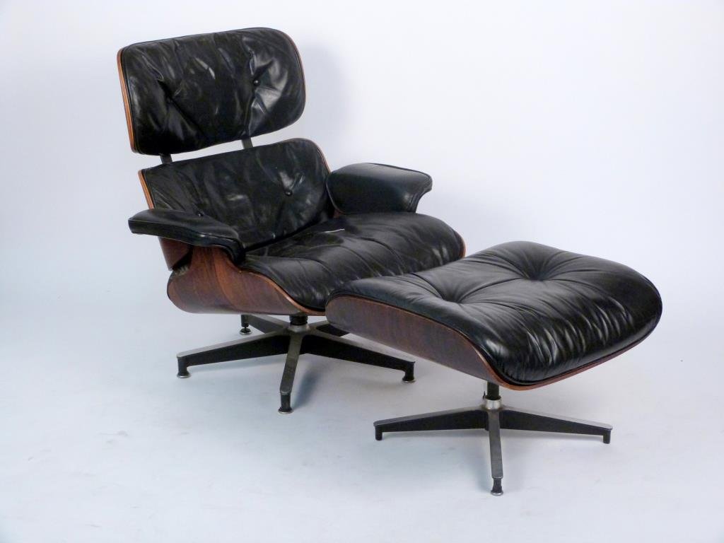 Charles and Ray Eames Rosewood 670 Lounge Chair: Rosewood frame with tufted black leather seat, Herman Miller label; together with 671 Ottoman. 32" W X 34" D X 32 1/2" H; ottoman: 25 1/2" W X 22" D X 16 1/2" H. Ottoman missing 2 feet, chair missing 