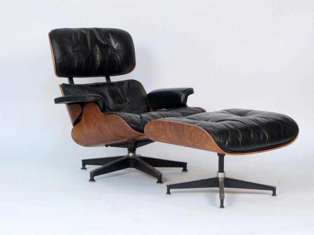 Charles and Ray Eames Rosewood 670 Lounge Chair: Charles and Ray Eames Rosewood 670 Lounge Chair and 671 Ottoman. Rosewood frame with tufted black leather, enameled aluminum.. 32" W X 34" D X 32 1/2" H; ottoman: 25 1/2" W X 22" D X 16 1/2" H. 1 head