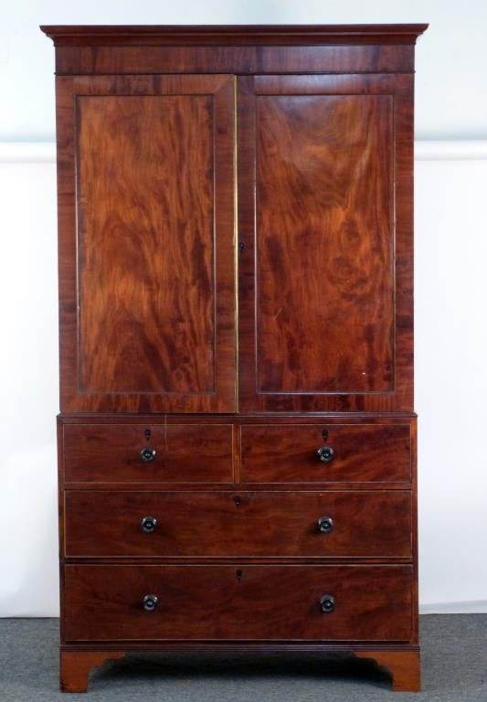 Antique English Mahogany Linen Press: In 2 parts, doors opening to pull out shelves, over 5 drawers, ebonized wood drawer pulls and escutcheons. 50 1/2" W X 22" D X 88 1/2" H. (Madison Avenue NYC Estate)
