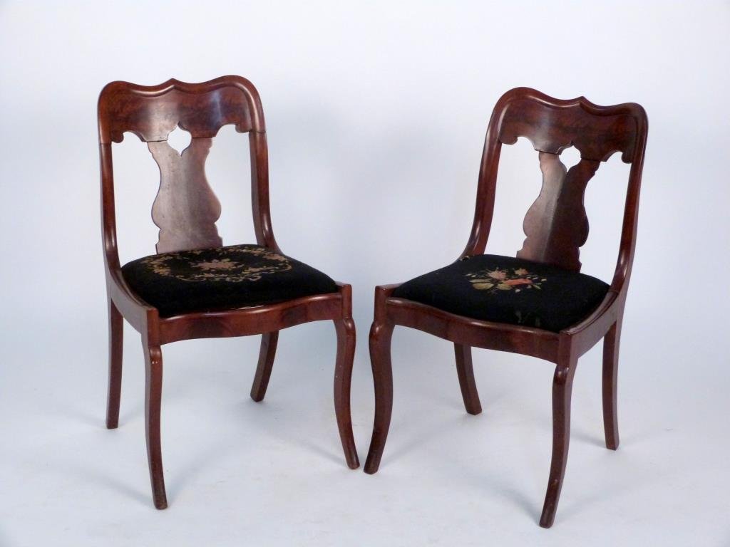 Pair of American Empire Side Chairs: Saber legs, baluster shaped back splat, needlepoint slip seats. 18" W X 21" D X 31" H. (Brooklyn Heights Estate)