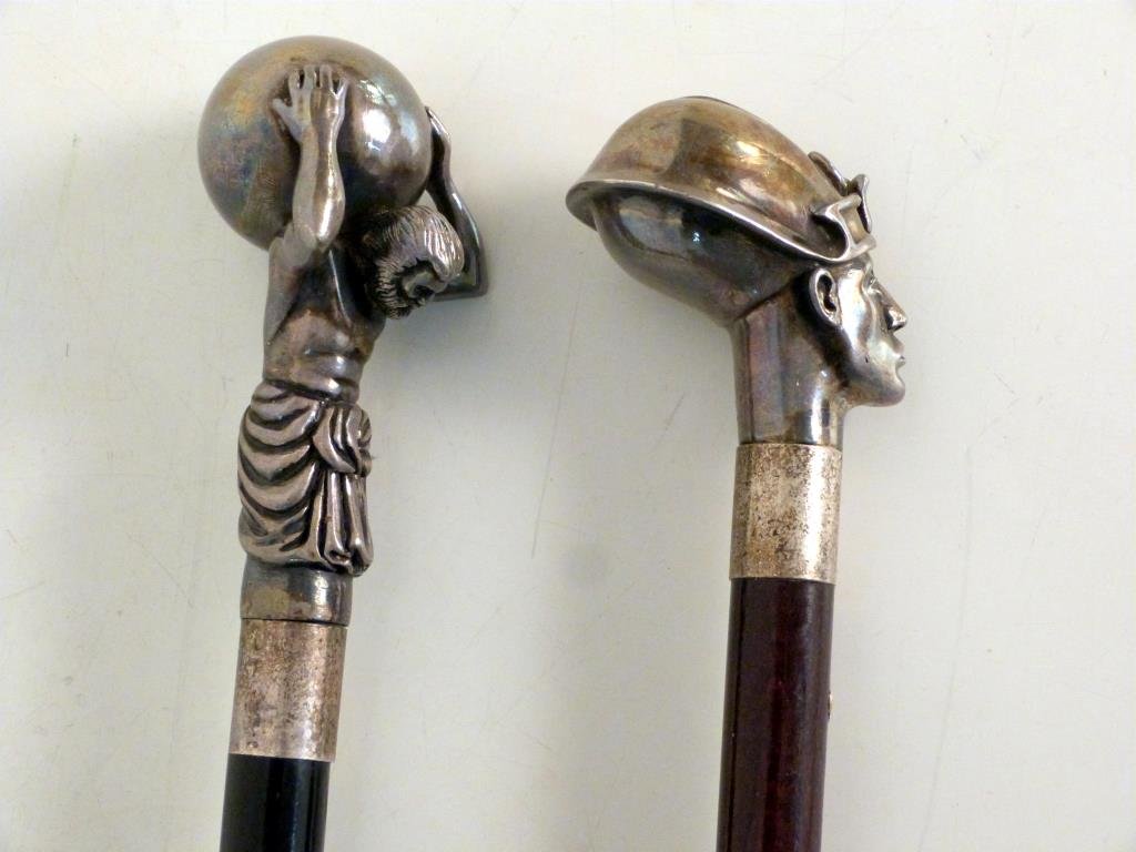 2 Sterling Silver Topped Walking Sticks: Atlas and Egyptian face, hallmarked, ebony and mahogany staffs. Taller: 38 1/2" H. (Keyword - Cane , Dandy)