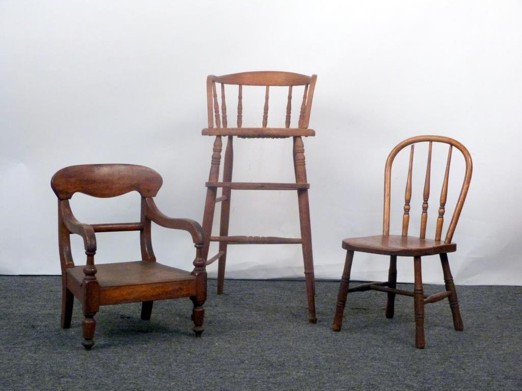 3 Antique & Vintage Children's Chairs: Carved wood open arm chair, turned wood and cane high chair, and spindle back side chair. High chair:14" W X 16" D X 32" H.