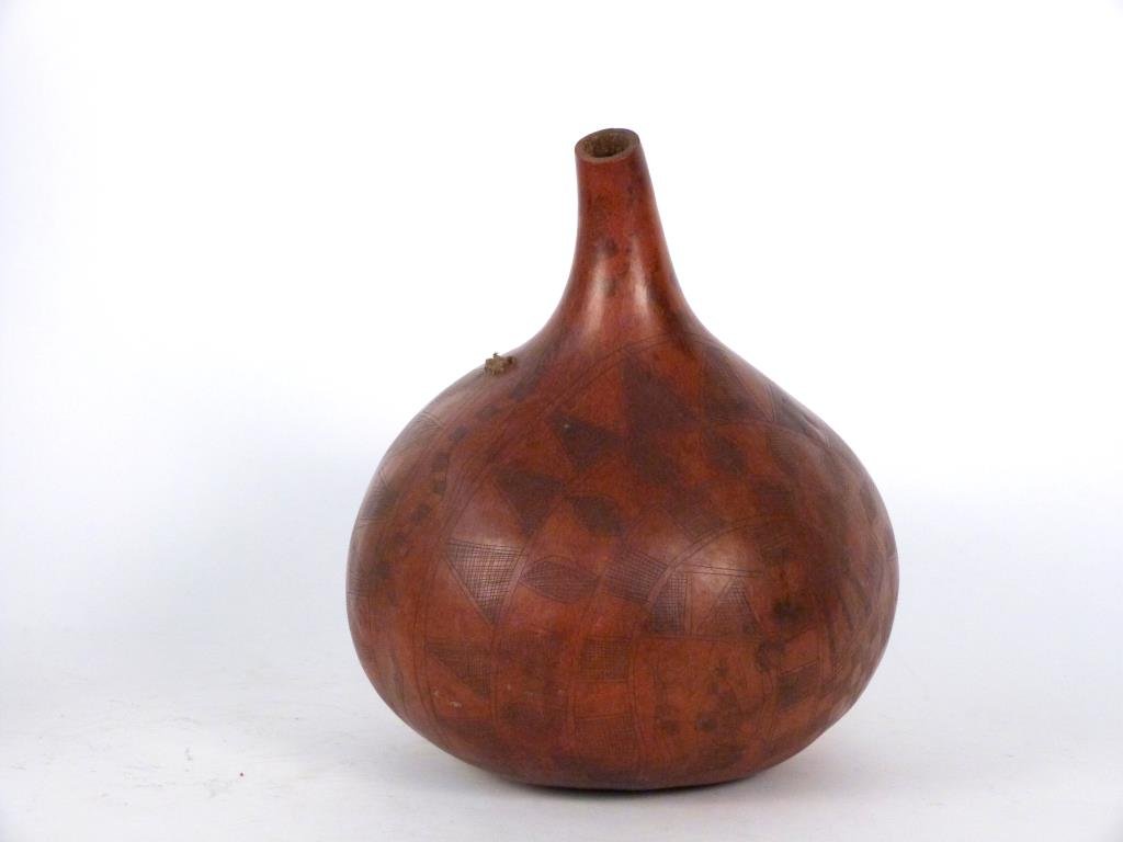 Aboriginal Style Incised Gourd: With abstract and reptile design and applied rope (possibly as signature on base). 14" H. (150 East 69 Street Estate).