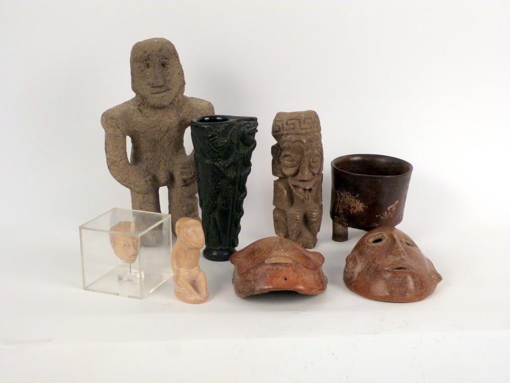 Assorted Pre-Columbian & Tribal Style Articles: Including 2 pottery masks, 2 carved volcanic stone figures, Aztec style cast revin vessel (possibly ancient), carved stone seated monkey, and terracotta head in plexiglass case. Tallest: 14 1/2" H.