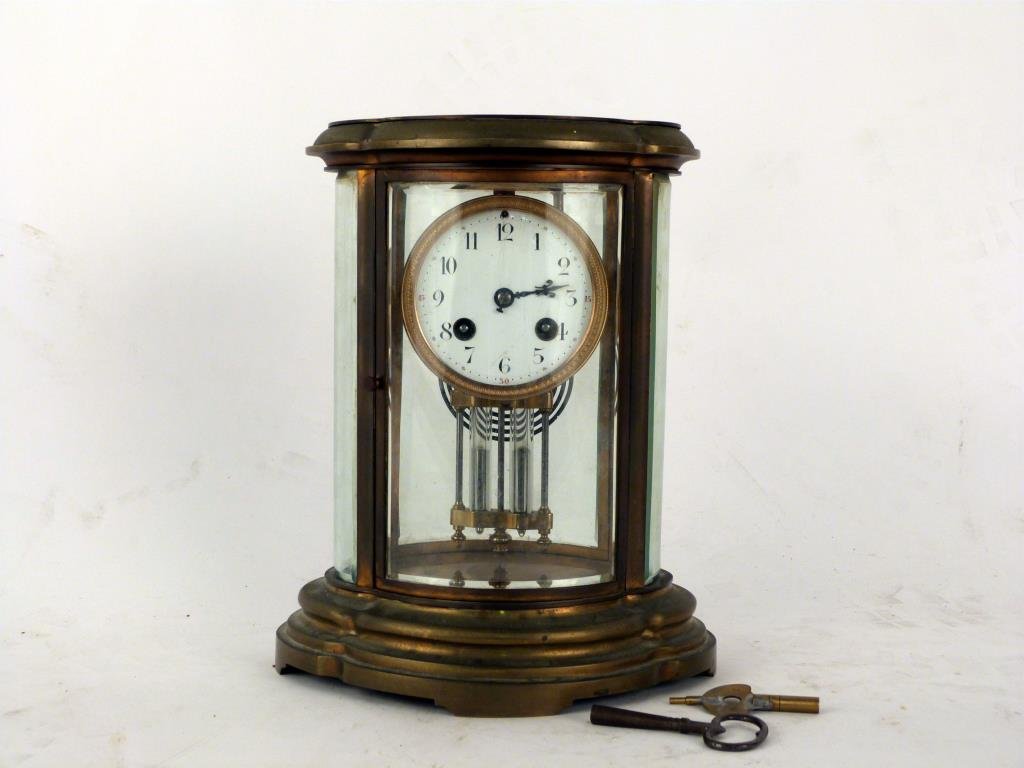 Brass Carriage Clock: Plastic face, brass and glass case. Mercury weighted pendulum. 10 1/4" H.