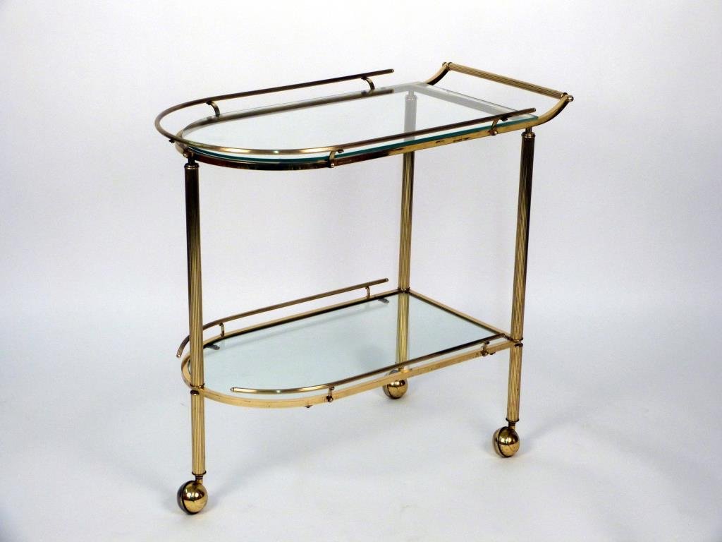 Art Deco Style 2 Tier Bar Cart: Fluted brass, glass shelves on casters. 32" W X 18" D X 29 1/2" H. (From an East Side Townhouse)