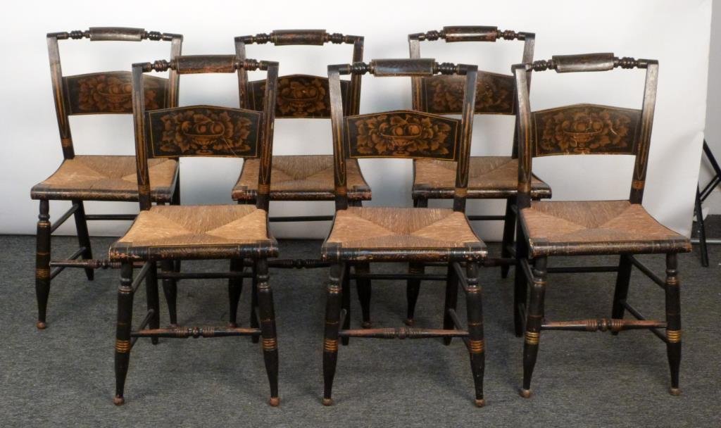 Set of 6 Hitchcock Style Side Chairs: Ebonized carved wood frames with gilt painting and rush seats. 17 W X 14 1/2 D X 34 H. (Rye, NY Estate)