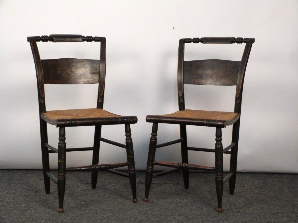 Pair of Hitchcock Style Side Chairs: Ebonized carved wood frames with gilt painting and rush seats. 17 W X 14 1/2 D X 34 H. (Rye, NY Estate)