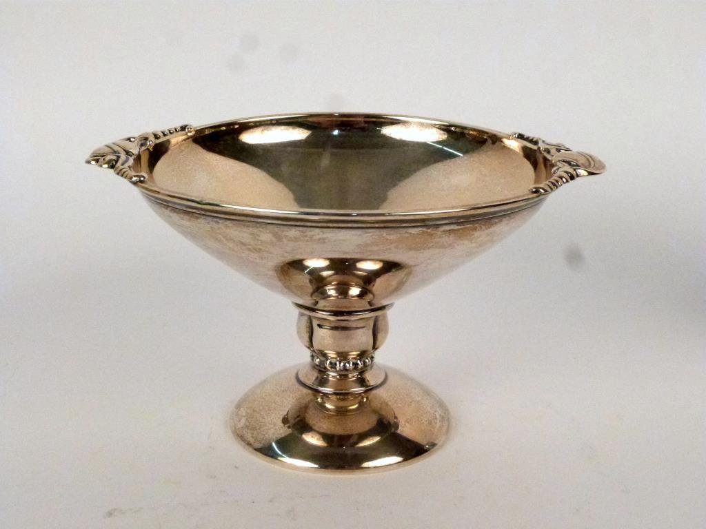 Sterling Silver Footed Compote: Trumpet mouth with foliate form handles, on pedestal base. 4 1/2 H. 9.5 troy oz."