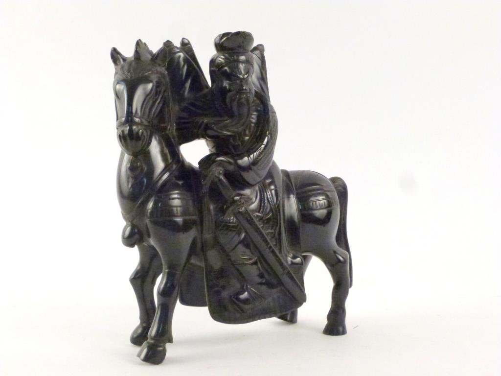 Chinese Figure of Equestrian: Amber colored Resin (shows Red through a high power flashlight), molded and incised. 9 1/2 H. Repaired."