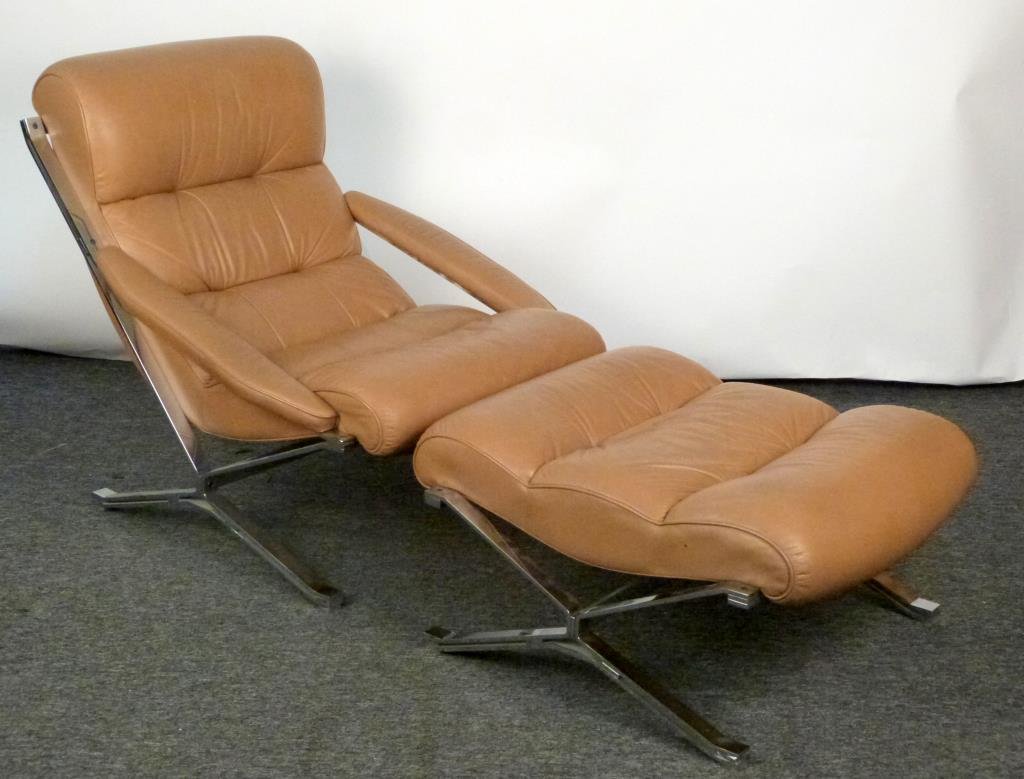 Chrome & Leather Lounge Chair & Ottoman: Modernist. Light brown channel upholstery. Chair: 32 W X 43" D X 35"; ottoman: 31 1/2" W X 28" D X 16" H. (From an East 79th Street Estate)"