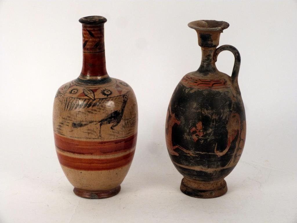 2 Antiqued Terra Cotta Amphora Vessels: Vase with animal designs under glaze, Pitcher depicting winged Mercury. Both with repairs, Fragile. 12H. (Property of a Mamaroneck NY Private Collector)"