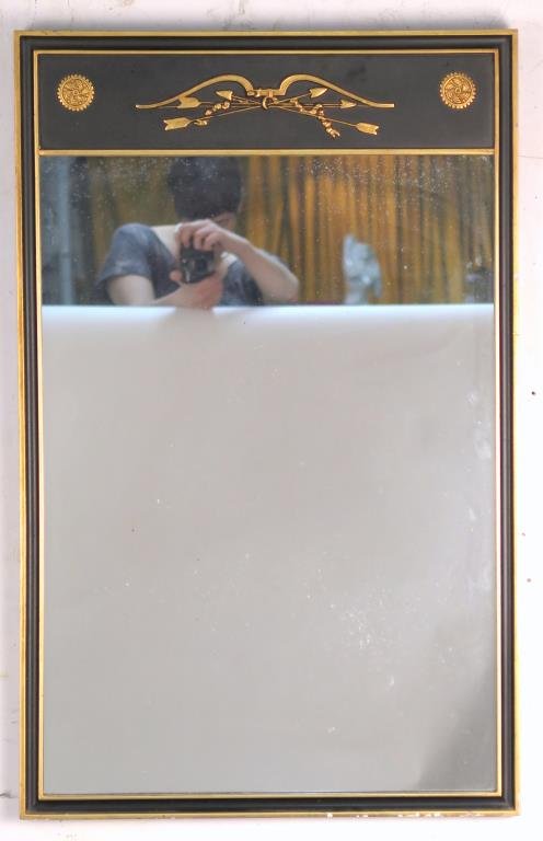 Federal Style Mirror: Ebonized frame with gilt bow and arrow, rosettes, and borders. 34 H X 21.5" W."