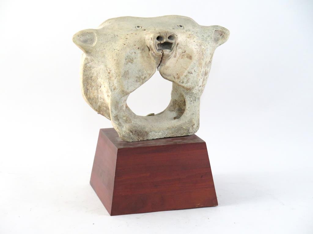 Unusual Inuit Carved Artistic Whale Bone: Transformation piece with animal features on both sides. 12 H X 15" W, mounted on 6" wood base."