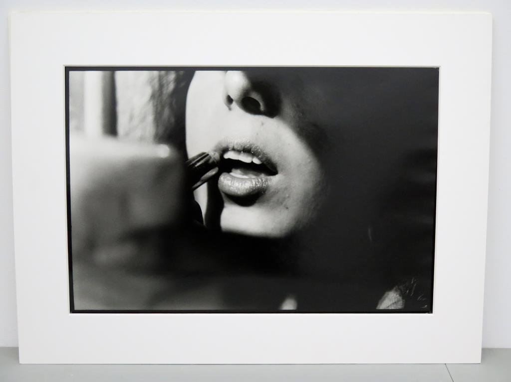 Harriet Logan (XX - XXI) - Photograph: Black and white photo signed and titled on verso Marina" 1997. Ed. 1/10. Marina applying lipstick in defiance....