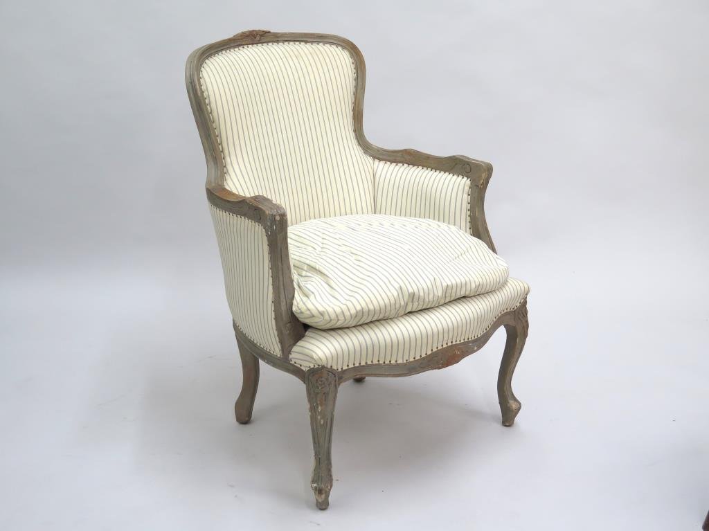 French Style Bergere: Painted Carved wood frame, striped upholstery and burlap back in good condition. 26" W X 28" D X 36" H.