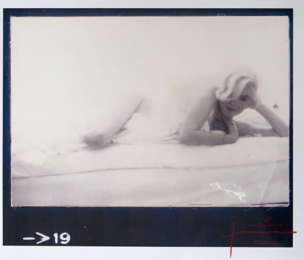 Bert Stern (American, 1929-2013)- Photograph: Marilyn Monroe reclining, signed lower right and stamped on reverse, Photo on paper. 13 H X 19" W."