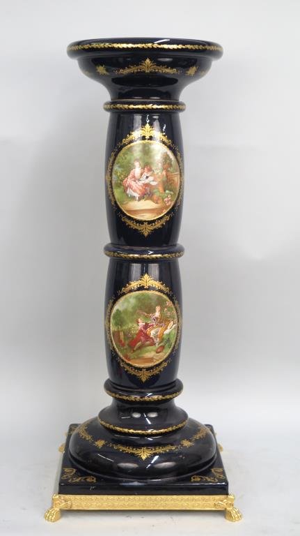 Cobalt Limoges Style Pedestal: Featuring romantic scenes After Fragonard. On painted metal base ending in paw feet. Some scuffs on top of pedestal, two chips to porcelain base. As is. 15.5"W X 15.5"D (base) X 35.5"H