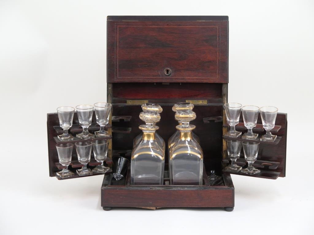 Inlaid Mahogany Tantalus (as is): 4 gilt trimmed decanters with stoppers with 12 cordials, also gilt trimmed. One cordial broken at stem. Slight chips on bottoms of decanters and a few on cordials. Box needs restorations. 12 X 9" X 10