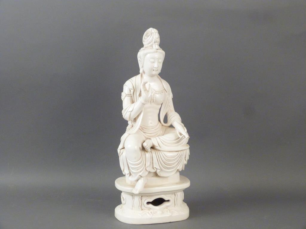 Finely Detailed Porcelain Bodhisattva Figure: Seated upon a lily pad over a pierced base with alternating dragon and flower designs. Stamped at base of water lily. Some dirt. 8"W X 6"D X 17.75"H