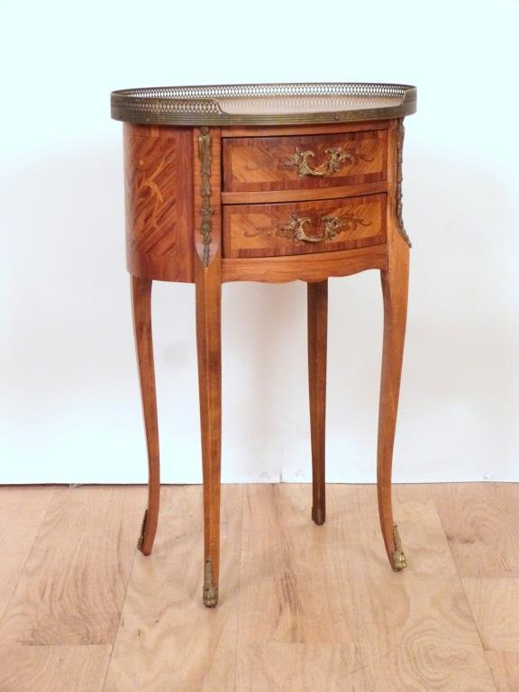 French Oval Petite Commode: Inlaid 3/4 gallery top. Gilt metal mounted. Finished back. 17W X 13"D X 26.5"H. (Estate of Dwain DePaul, Brooklyn, NY)"
