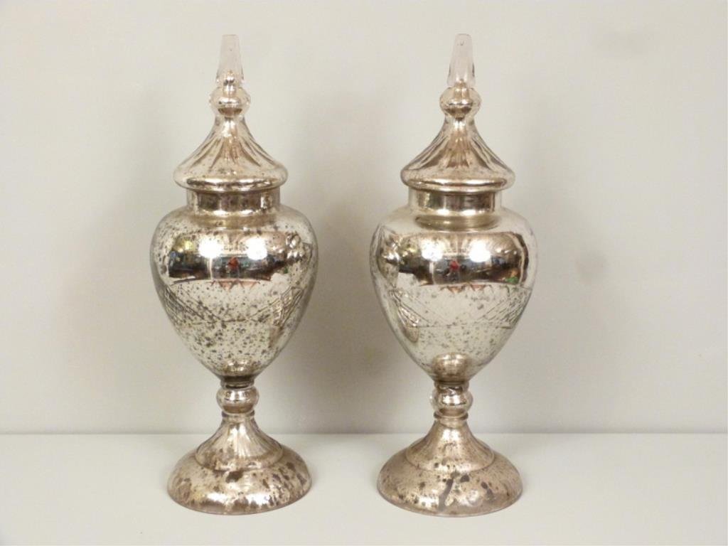 Pair Mercury Glass Covered Urns: Etched and beveled front design with side and back star and circle designs. Finials may have been buffed down and smoothed. Slight chips. 10"dia X 25"H.