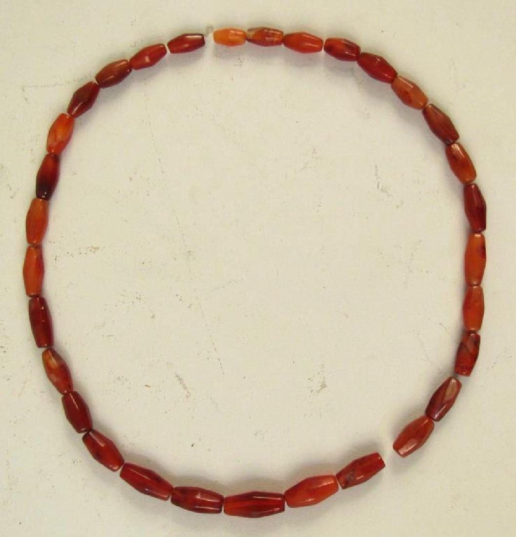 Carnelian Necklace: One bead with chip.
