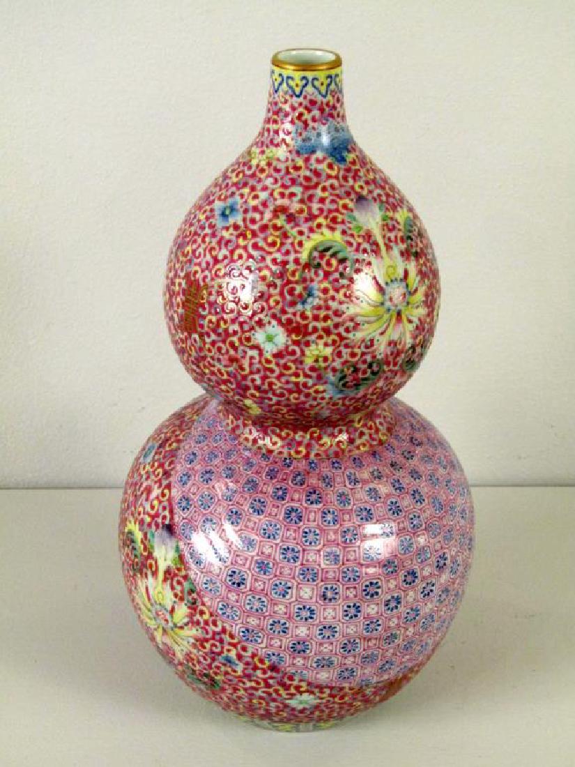 Chinese Enameled Ribbon Decorated Vase: Double Gourd shape with gilt rim, incised scroll and flower designs. The ruffling of the handkerchief design is matched with the texture of the porcelain to the molded ribbon design at center. Signed 