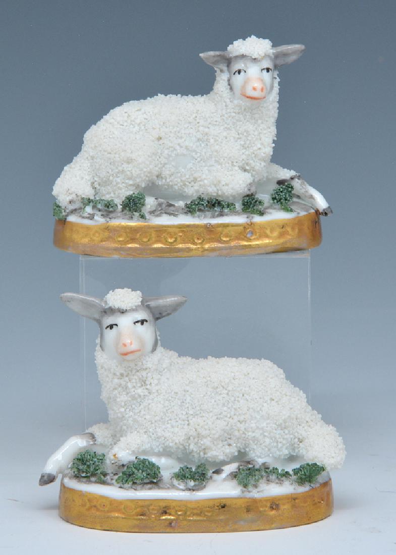 2 Chelsea porcelain sheep, 18th c: 2 Chelsea porcelain reclining sheep, facing design, gilt decoration at bases c 1760, gold anchor marks. Appx 2 3/8"l. Some losses to "fur".