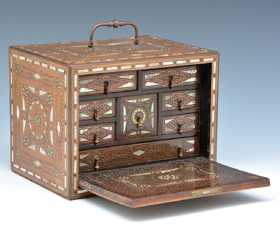 Rosewood jewelry casket with mother of pearl inlay: Rosewood jewelry casket, intricate mother of pearl and brass inlay, front opens to reveal 8 drawers all with inlay, comes with key, appx 6 1/2"t x 8 1/2"w x 6 1/2"d. In very good condition.