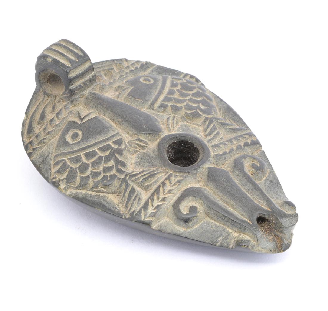 Ancient black stone oil lamp decorated with fish (1 of 4)
