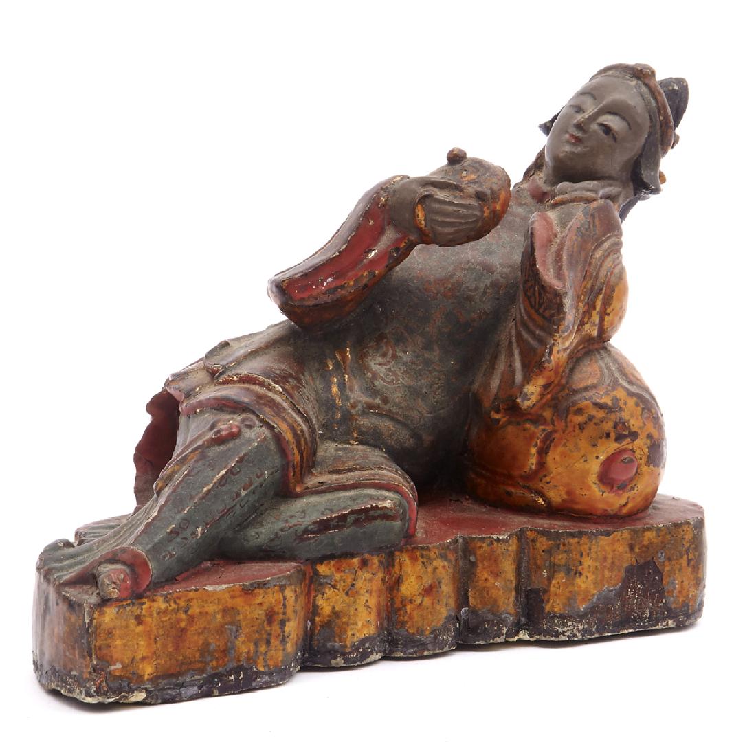 Chinese lacquered stone statue of a reclining woman: Chinese statue of a reclining woman holding a teapot, stone covered in polychrome lacquer. Appx 8 1/2"l. Teapot lacks spout.