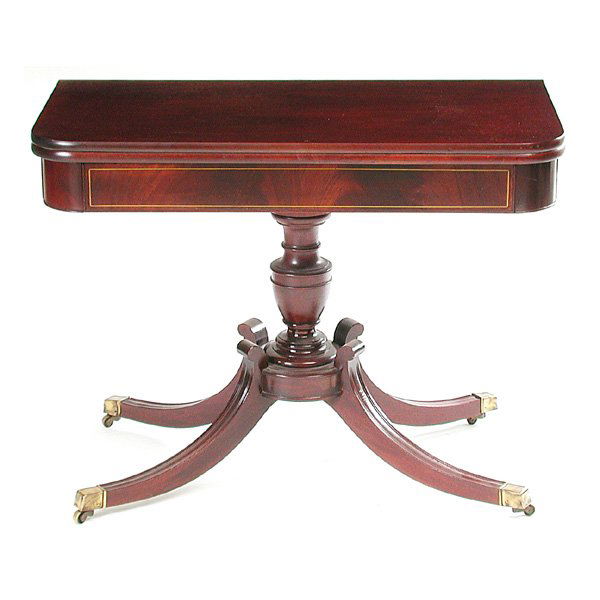 American Mahogany Games Table: TABLE. American Mahogany games table in the Duncan Phyfe manner, the top swivels, opening to full size, the apron decorated with framing inlay, very good condition, (closed - 38"w x 19"d x 29"h) (open