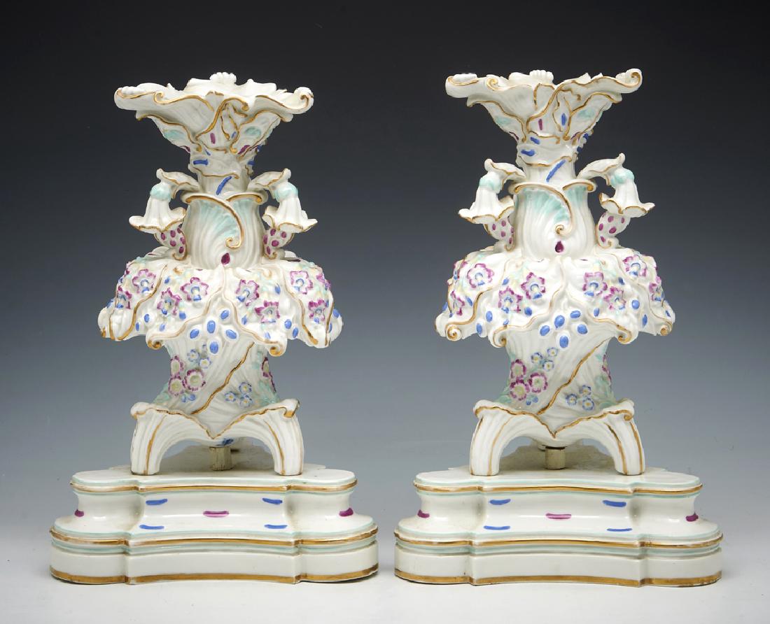 Pair of Jacob Petit elaborate porcelain tripod epergnes: Pair of Jacob Petit elaborate porcelain tripod epergnes on triangular bases in floral motif, gilt detailing, marked "JP" inside bases. Appx 15"h. Very good condition.